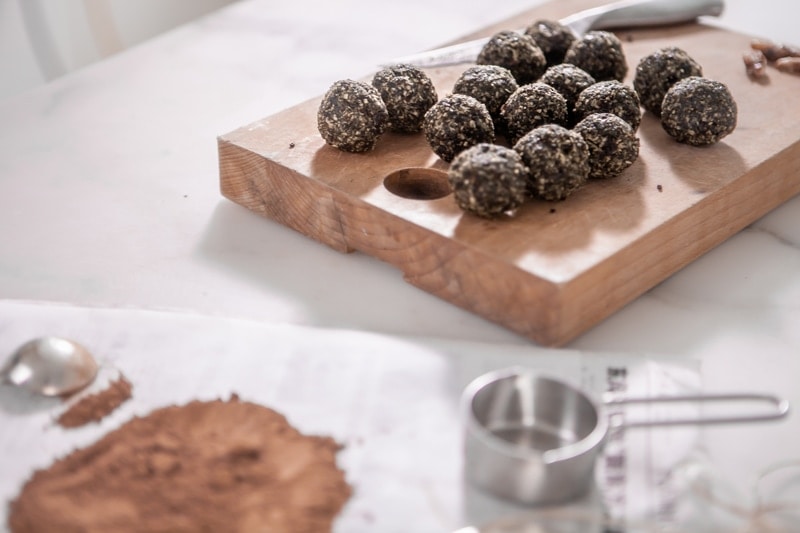 Freshly made energy balls on a wooden board