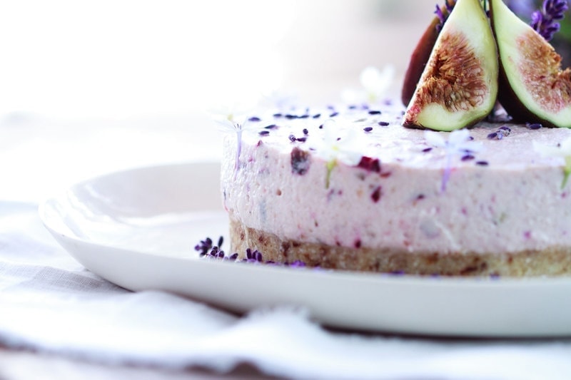 Side profile of the lavender cake on a plate on a rustic table