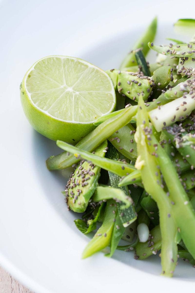 Close up of a vegetable salad and half a juicy lime