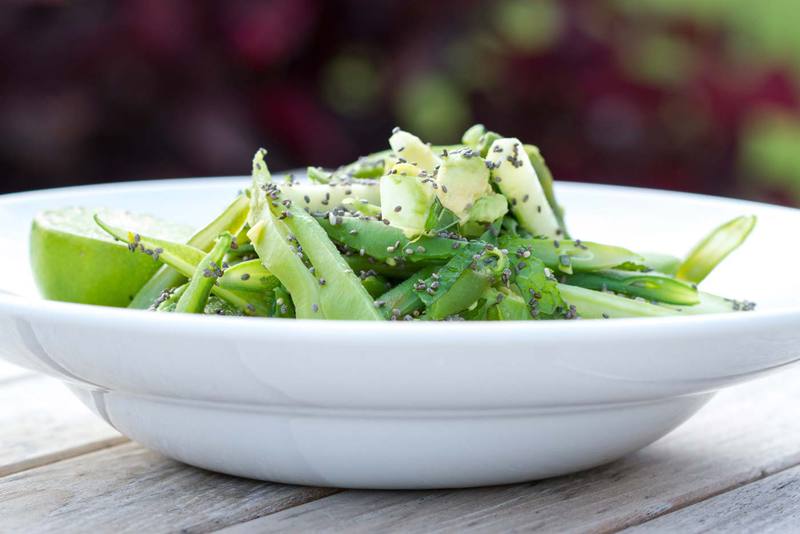 Bowl of fresh green vegetable salad in an outdoor setting