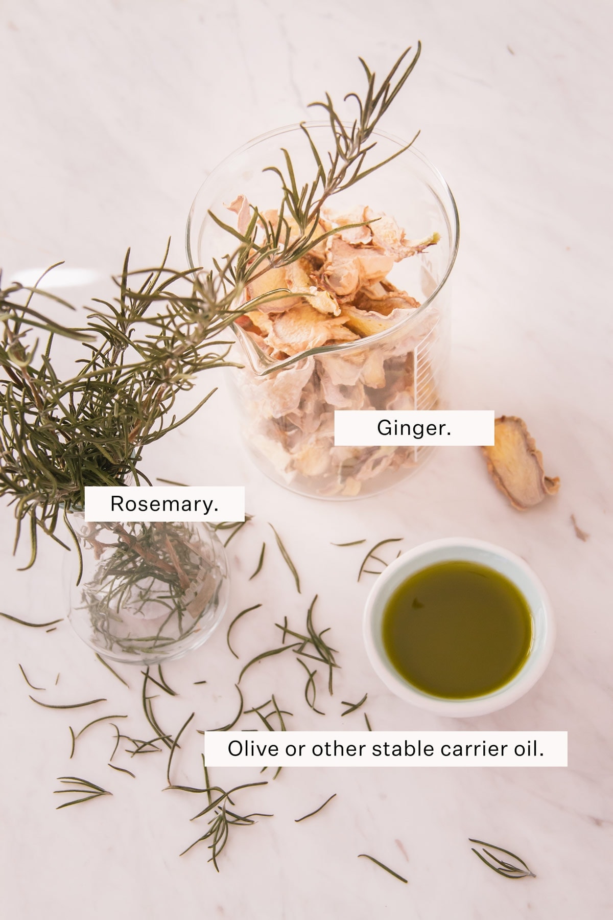 Flat lay of ingredients for rosemary and ginger infused oill