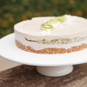 Raw cake on a cake stand on an outdoor table