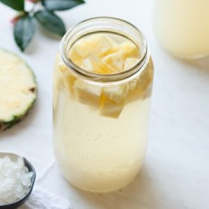 Jar of pineapple kefir bubbling away on the kitchen bench