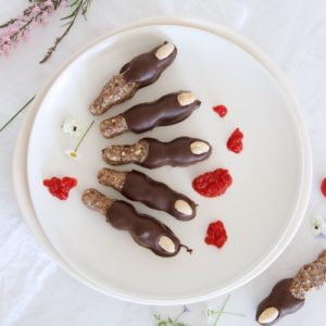 A plate of cookies shaped into Witches' fingers with smashed raspberries for blood