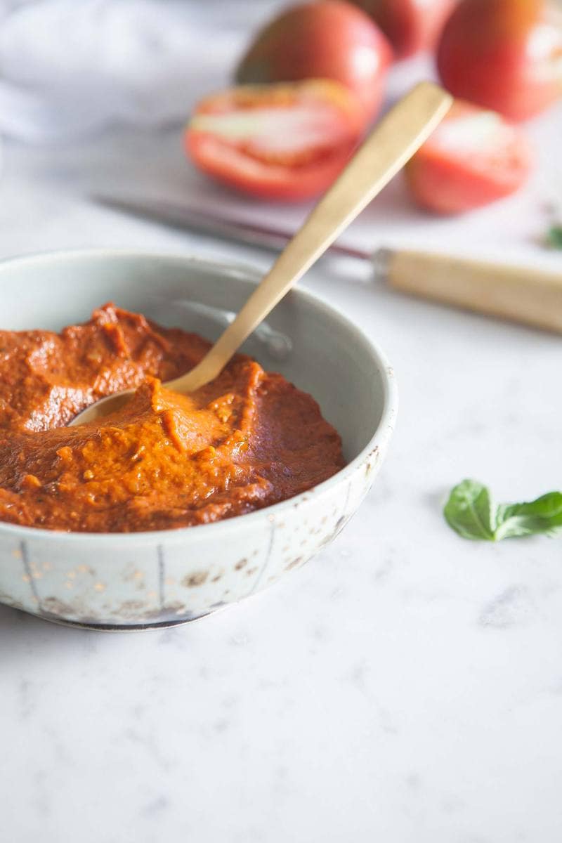 Close up of the tomato soup in a bowl, showing the texture and lush colour.
