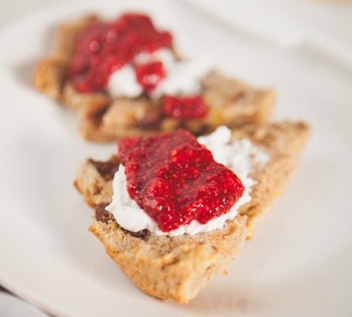 Freshly baked gluten free date scones with coconut cream and chia jam spread over the top