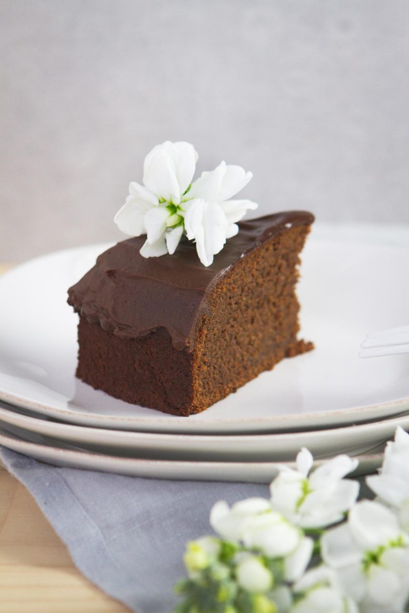 A slice of gluten free vegan chocolate cake on a plate