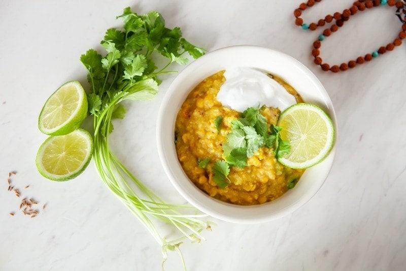 Bowl filled with freshly made kitchari on a marble surface.