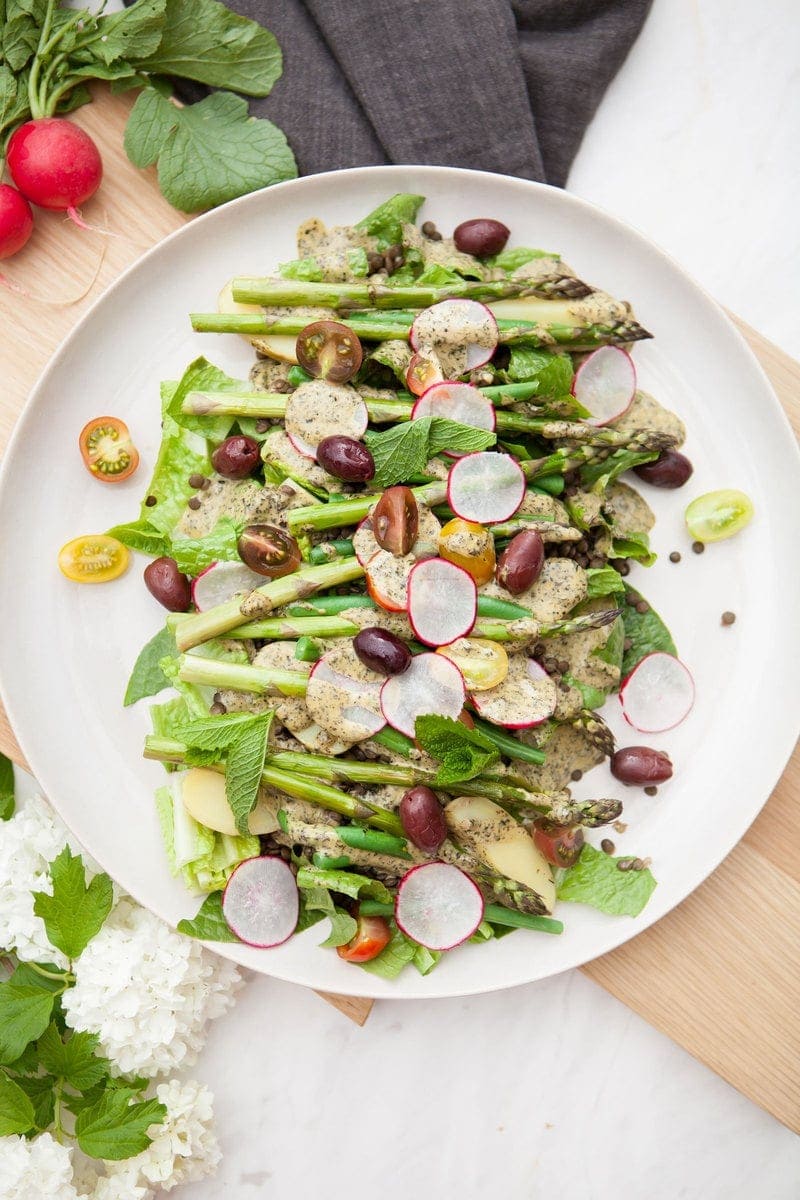 Close up of a Nicoise Salad recipe made with a vegan nicoise salad dressing, on an outdoor table