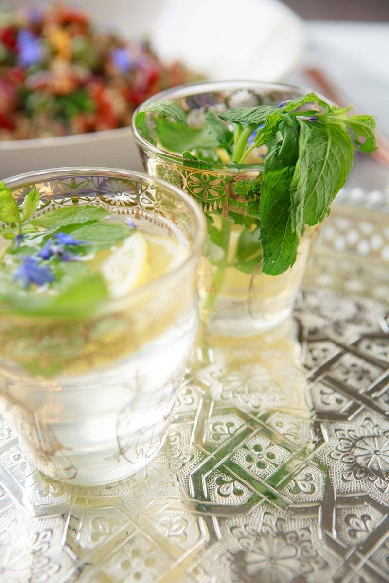 Close up of two Moroccan tea glassed filled with lemon and mint