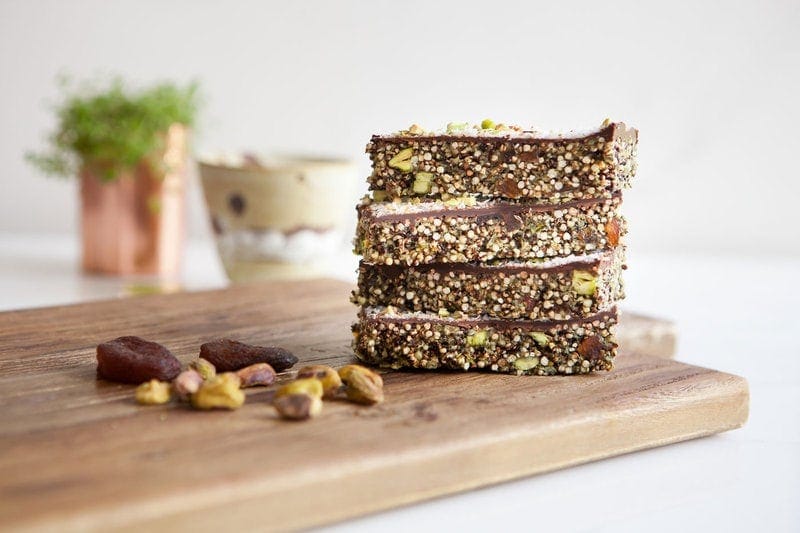 Apricot Chocolate Popped Quinoa Bars stacked on a wooden board