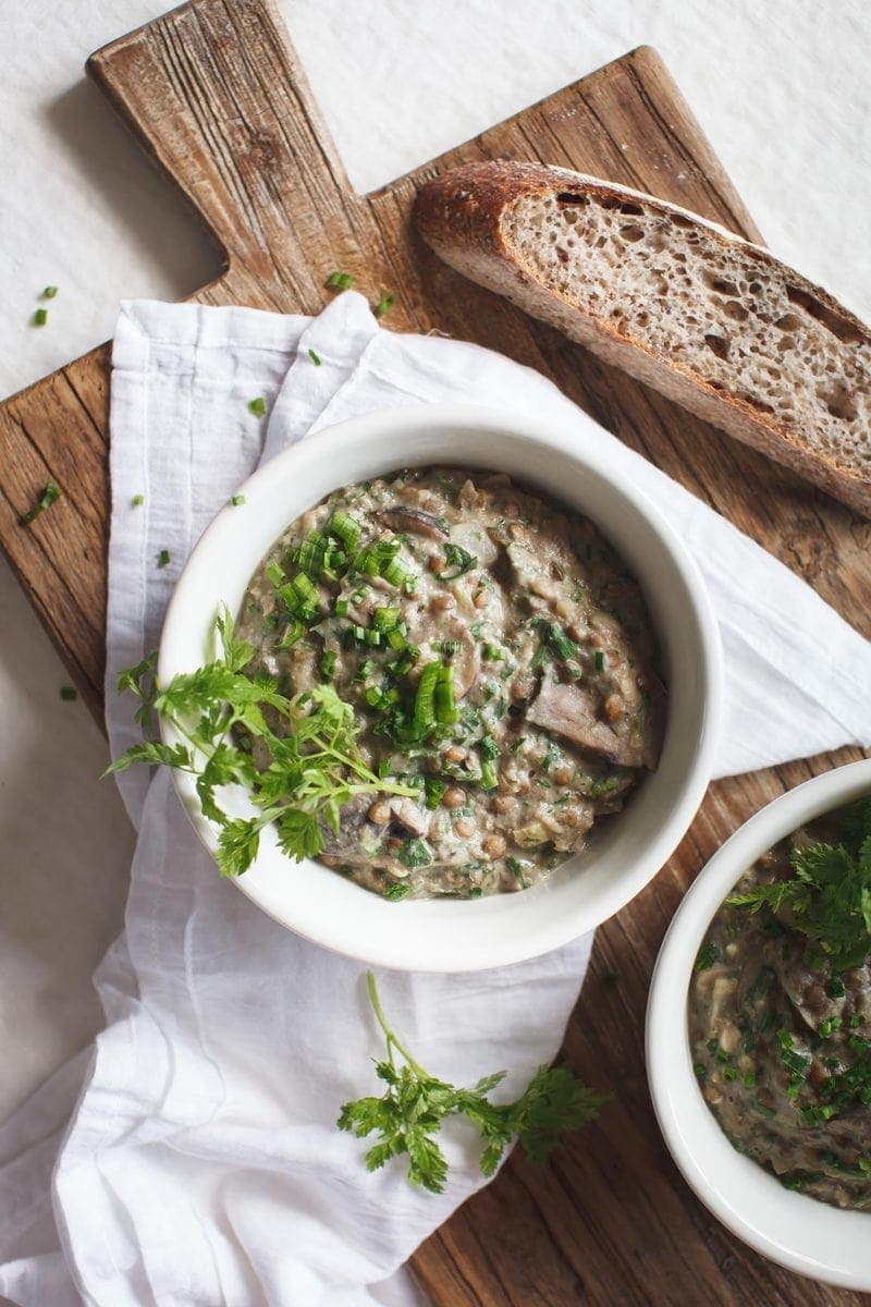 Cozy Creamy Mushroom Lentil Stew with fresh herbs scattered over the top