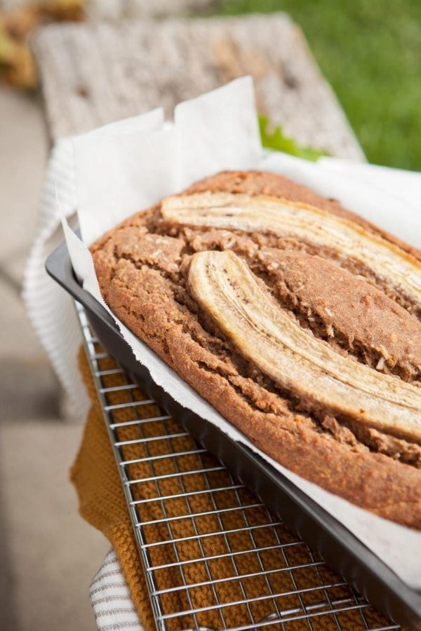 Close up of fresh baked gluten free vegan banana bread with caramelised banana halves pressed into the surface