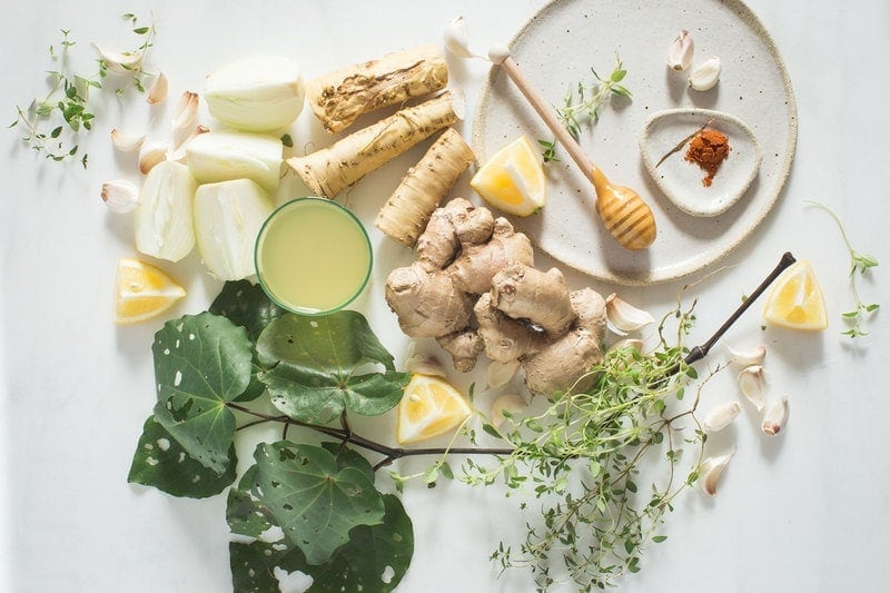 Flat lay of ingredients for a herbal immune tonic - also known as fire cider