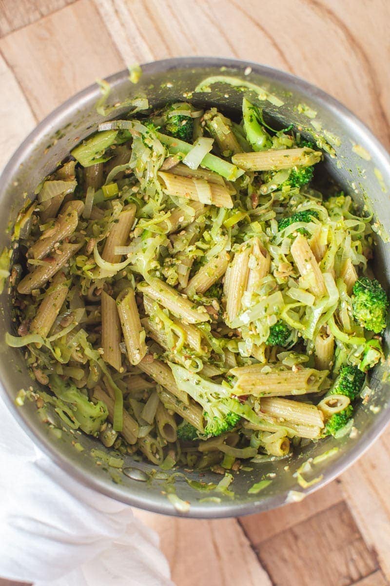 Broccoli Pasta in the making - combing the cooked legume pasta with the pesto and greens