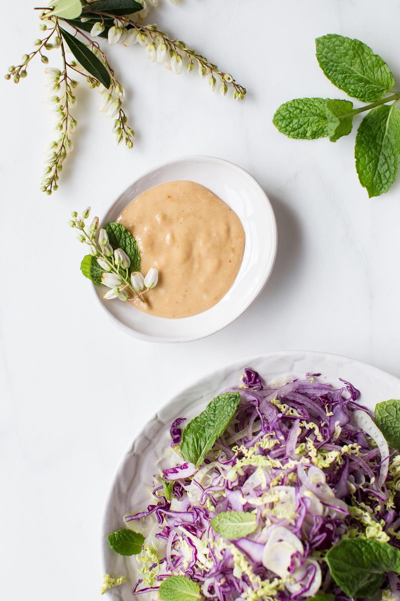 Close up of sweet and creamy miso tahini dressing in a side bowl