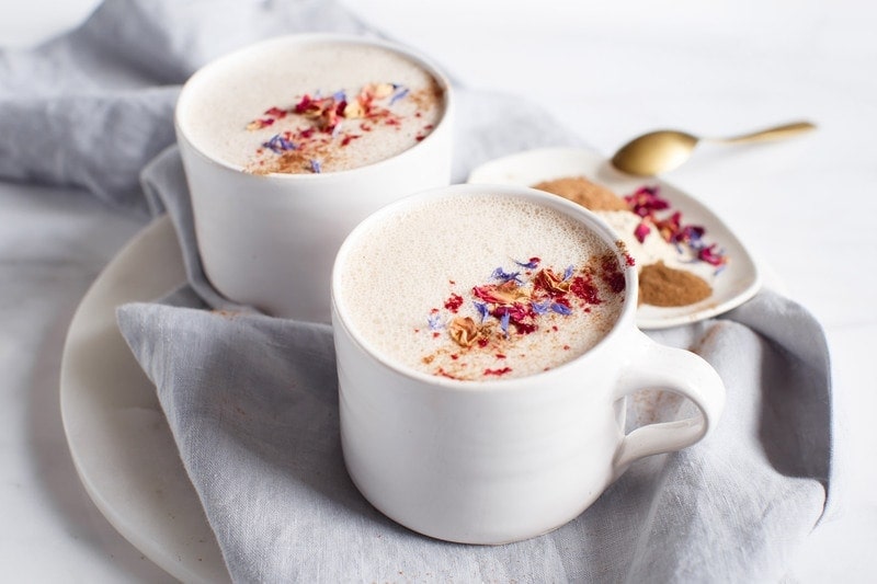 Two mugs of warm milk infused with the herb ashwagandha for restful sleep