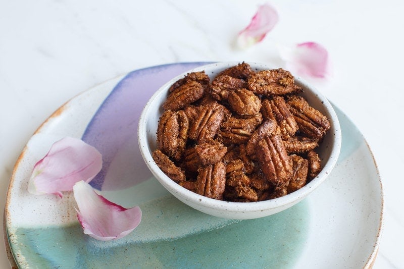 Small ceramic bowl filled with spiced pecans