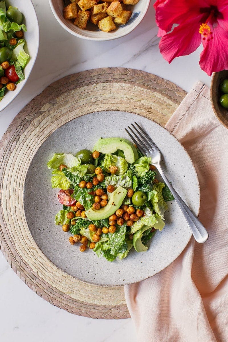 Vegan Caesar salad being served on a dinner plate