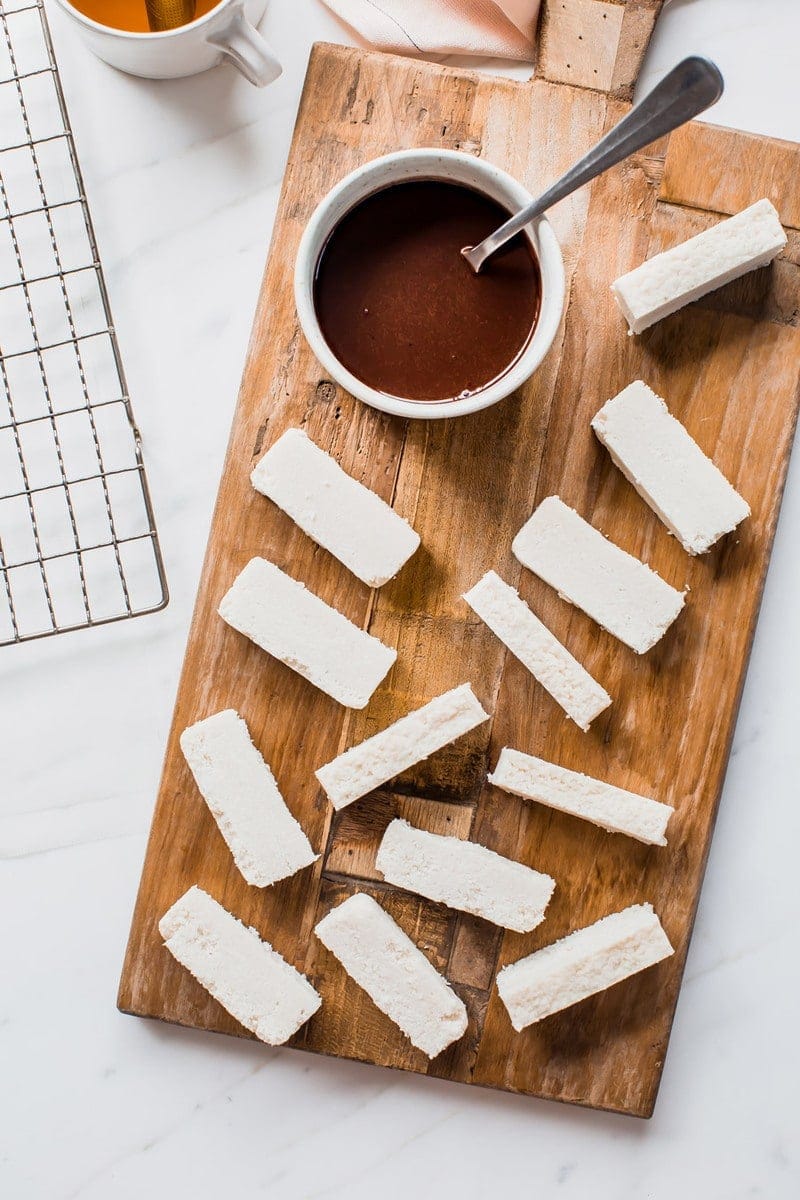 Sliced raw bounty bars on a board ready to be dunked in chocolate