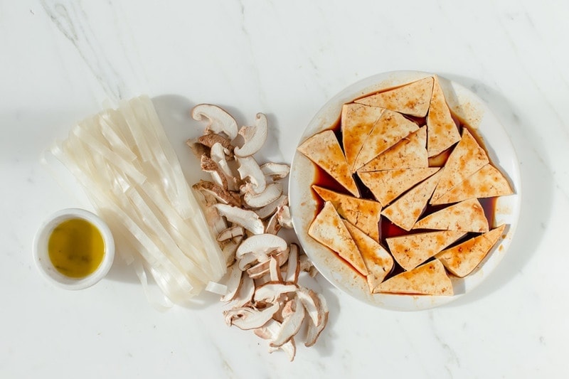 Ingredients used in a vegan Pho, laid out on a kitchen bench