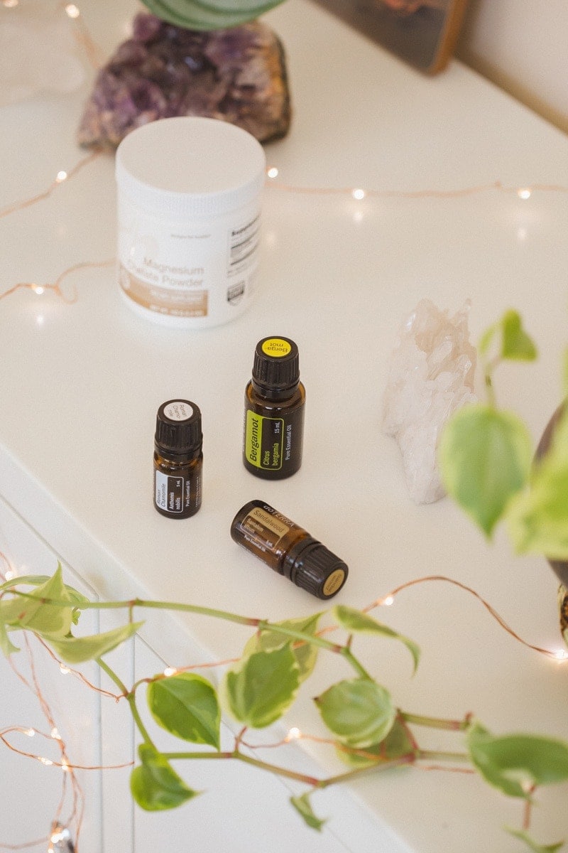 A trio of essential oils for sleep on a white cabinet