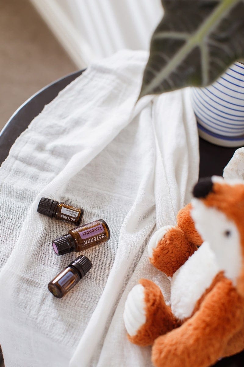 Lavender, Chamomile and Juniper Berry Essential Oils for Kid's Sleep, on a beside table