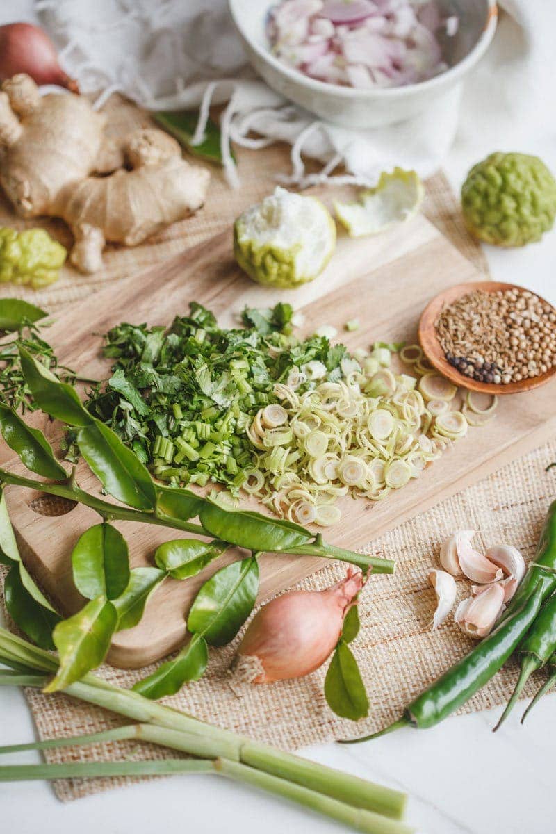 Fresh ingredients for a vegan Thai Green Curry Paste recipe on the kitchen counter
