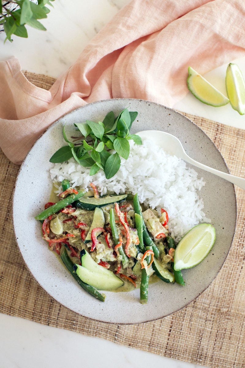 A freshly made Thai green Curry with tofu and fresh vegetables on a plate 