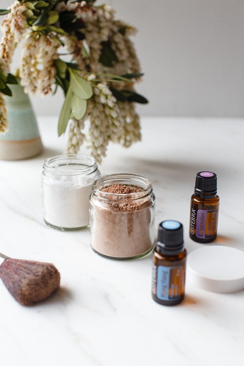 Bathroom vanity with pottles of DIY dry shampoo for various hair colours