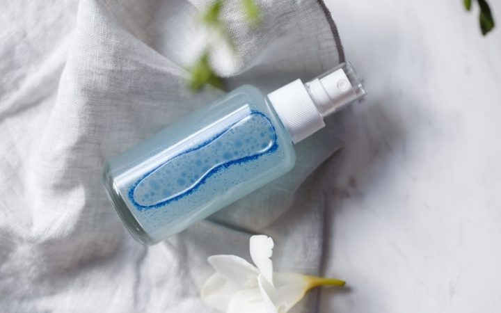 A bottle of homemade facial toner - a luminous blue colour