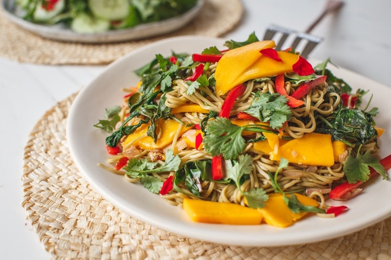 Close up of a colourful soba noodle salad with mango