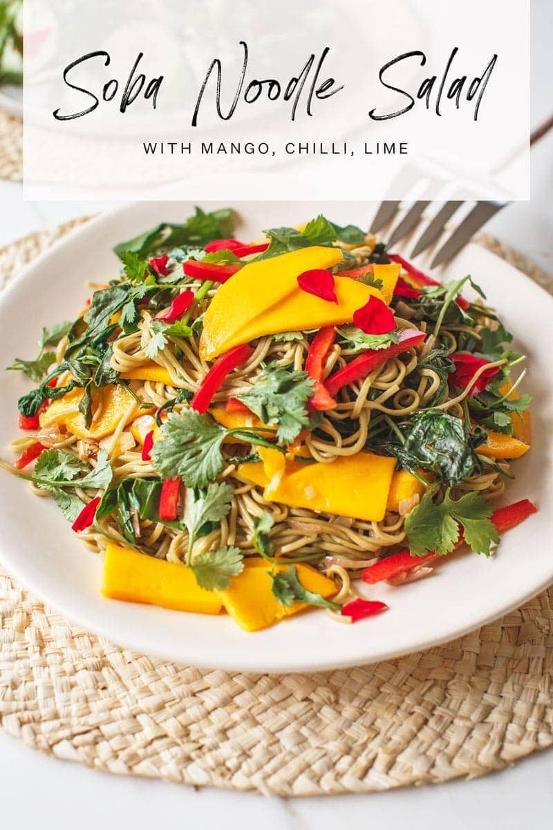 Mango Soba Noodle Salad on a woven placement with serving spoon