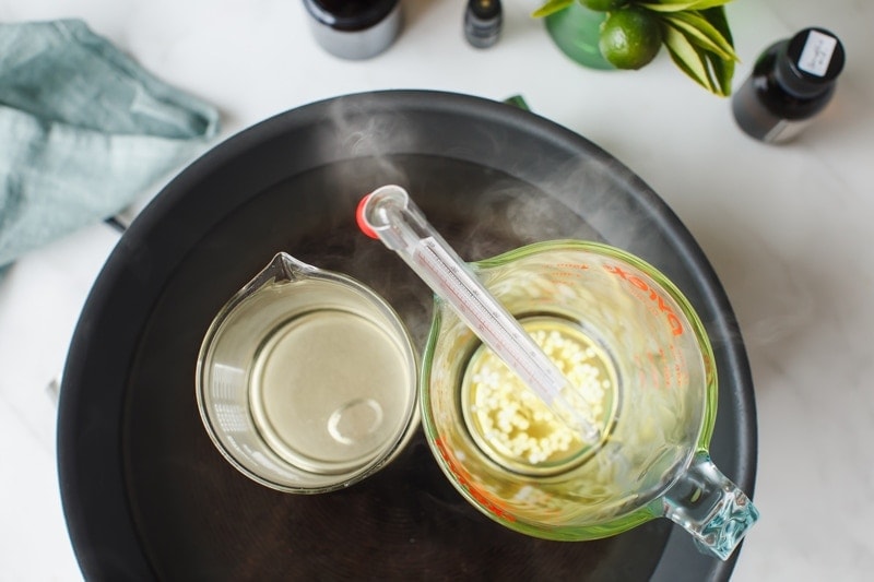 The oil and water phase - in pyrex jugs, over a double boiler - melting in order to make a homemade face cream