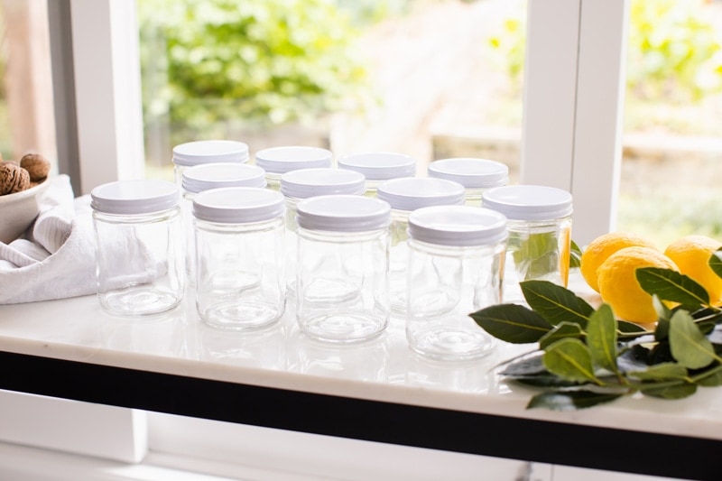 Sterilised canning jars on the table ready to make preserved lemons