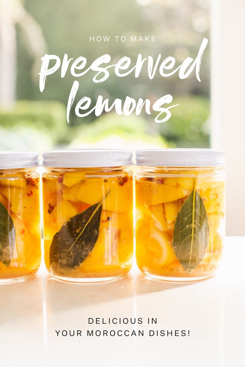 Gorgeous shot of three jars of preserved lemons with spices by the window