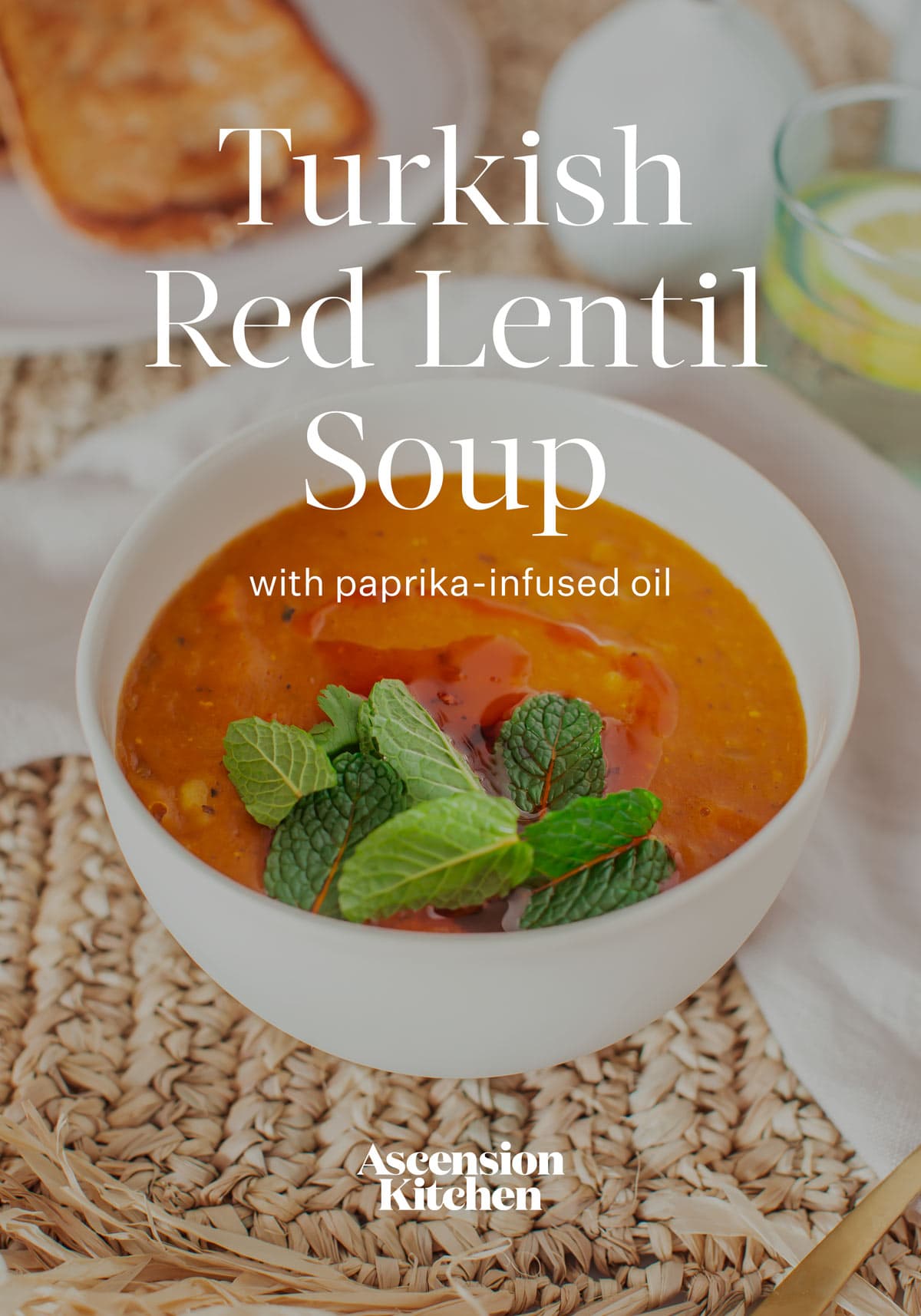 Ceramic bowl filled with a bright orange red creamy Turkish Lentil Soup, mint leaves on top