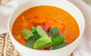 Bowl of Turkish lentil soup topped with mint and a drizzle of chilli oil.