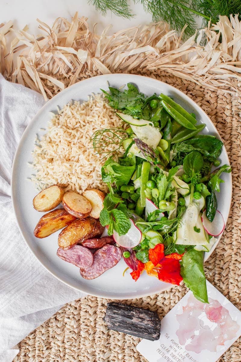 Dinner plate showing how to serve the asparagus salad - with brown rice, roast potatoes and kraut