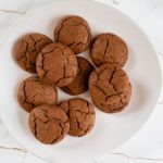 A plate full of delicious golden brown ginger cookies.