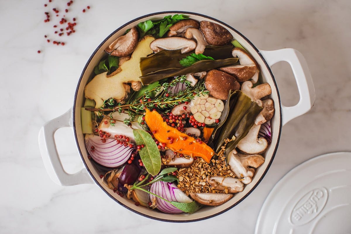 Hero shot of a stock pot filled with organic vegetables, medicinal herbs and spices, ready to make a broth.