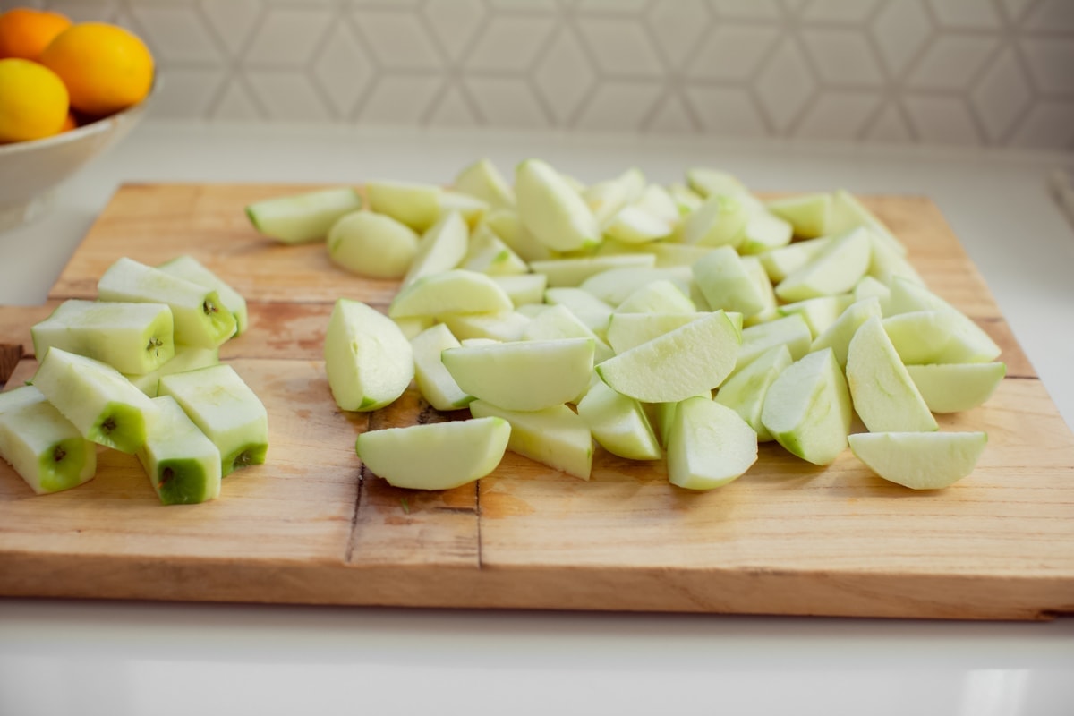 Peeled and cored apples cut into rough chunks ready to steam.