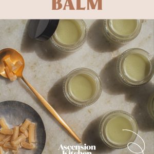 Beautifully styled shot of multiple jars of homemade balm with the recipe title printed over the top