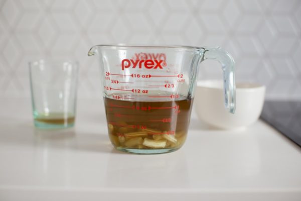 Infused oil and beeswax pastilles in a pyrex jug