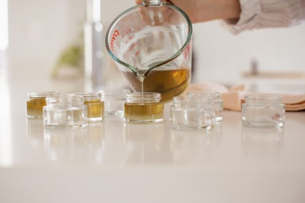 Lauren pouring the balm into individual jars