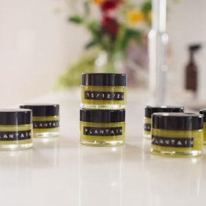 Jars of herbal salve on the kitchen bench