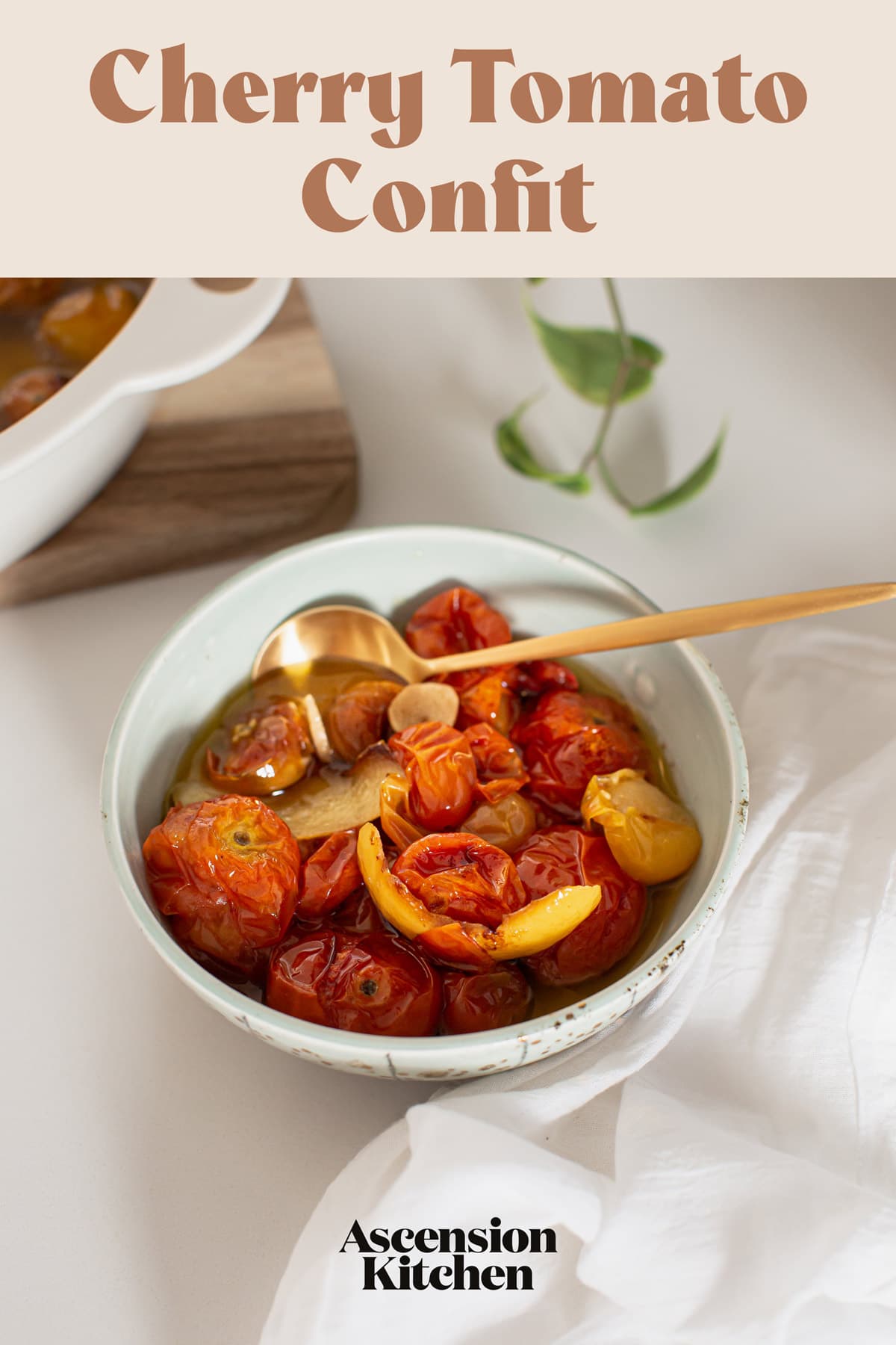 Hero image of a bowl of confit tomatoes in olive oil, with a golden spoon. The recipe title is printed over the top, for pinterest
