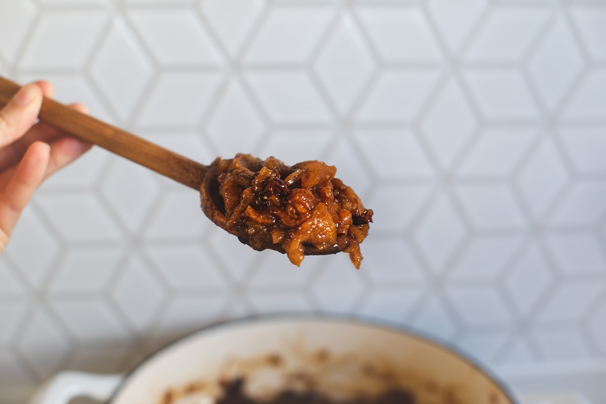 Lauren holding a wooden spoon topped with the finished chutney to demonstrate the end texture