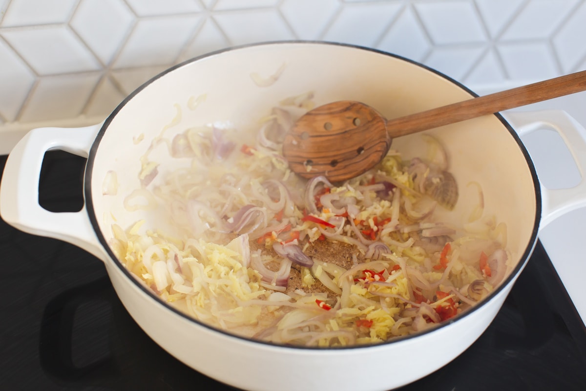 Cooking finely sliced onions, chilli, garlic and ginger in a large saucepan