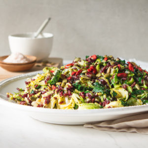 Forbidden rice salad topped with goji berries on a fancy platter.